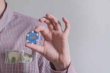 casino chips in the hands of the winner with money