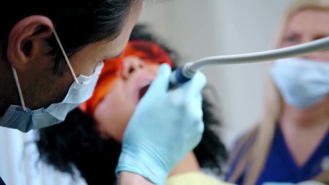 Dentist and his assitant working in private practice.