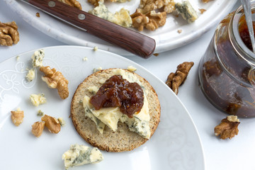 Closeup of stilton cheese and fig chutney on an oatcake