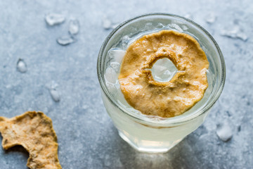 Pear Juice Cocktail with Dried Pear Slice and Crushed Ice.