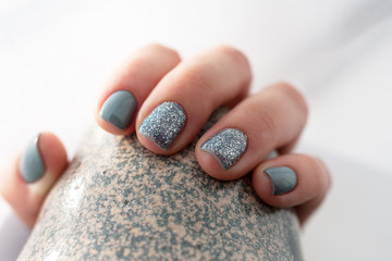 Green shellak gel nails on the ceramic japanise style mag