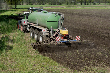 The manure is introduced into the field with a two-slice injection. Gütersloh, North Rhine-Westphalia, Germany, Europe.