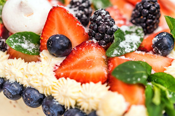 Delicious berry cake with cream close