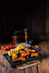 Rustic Grilled chicken wings,legs,and spicy corn