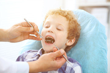 Close up of boy having his teeth examined by a dentist