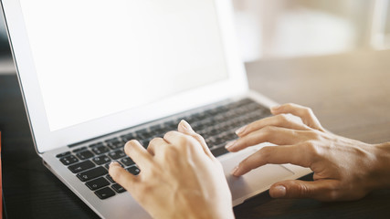 Female hands on an aluminum laptop keyboard typing working at home cafe woman writing typing on the keyboard