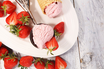 Delicious strawberry ice cream and waffle with fresh strawberries.
