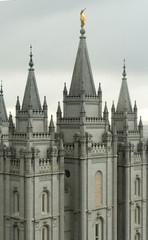 The Angel Moroni and the spires of Salt Lake Temple on an overcast spring evening. The Church of Jesus Christ of Latter-day Saints, Temple Square, Salt Lake City, Utah, USA.