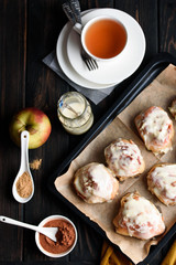 Sweet buns with a block and cinnamon on a dark background