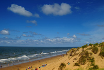 Sea beach and sand dunes. Sunny summer day