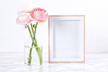 Poster frame mockup, front view, with decor elements, flowers and blank copy space over the white wall. - obrazy, fototapety, plakaty