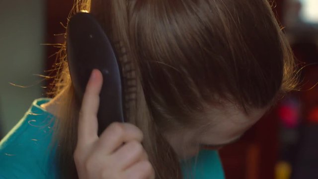 girl combing her hair
