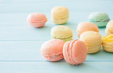 Assotrment of macarons on blue wood background
