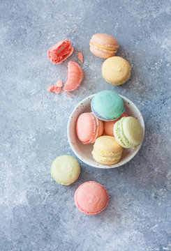 Assortment of macarons on blue stone  background