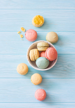 Assorment of macarons on blue wood background