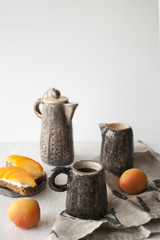 Sandwiches with sweet cheese and apricots, tea and a cup of coffee on a white wooden background