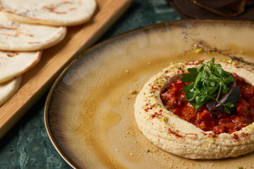 Baked vegetables with mashed potatoes and bread on a green marble table close-up. Healthy vegetarian food concept