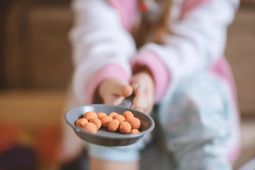 Little girl holds on the game frying pan kinetic sand, cooking game, entertainment and development
