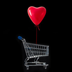 Balloon heart shaped  over of the shopping cart against the black background.