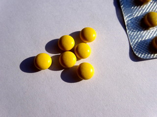 Yellow pills with blister pack on white