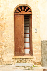 Fototapeta na wymiar Italy, Foggia, Apulia, SE Italy, Gargano National Park,Vieste. Old city, door with steep staircase.