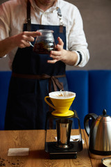 Barista making coffee, bartender or coffee maker preparing coffee drink