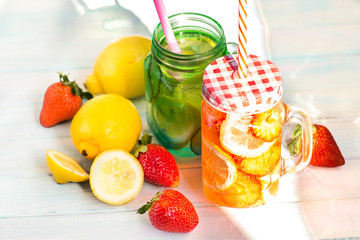 Summer background.Seasonal drinks. Lemonade fresh lemon with strawberries and lemon with fresh cucumber