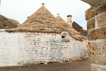 Fototapeta na wymiar Italy, SE Italy, Region of Apulia, Province of Bari, Itria Valley, Alberobello. A trullo house is a Apulian dry stone hut with a conical roof. UNESCO Heritage site.