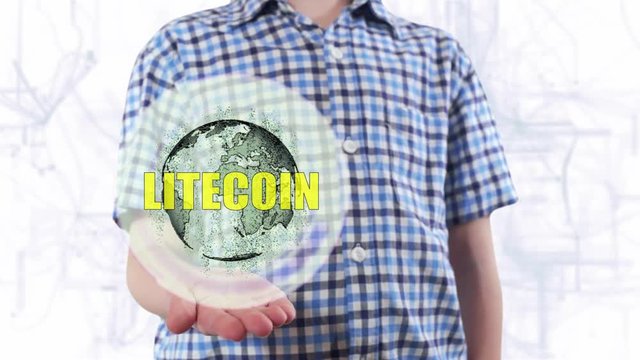 Young man shows a hologram of the planet Earth and text Litcoin. Boy with future technology 3d projection on a modern white digital background