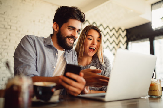 Happy couple shopping online by using laptop, smartphone and credit card