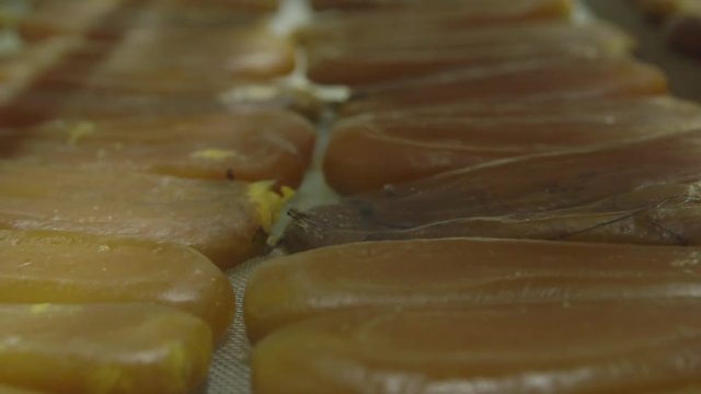 Close up, bottarga on conveyer belt