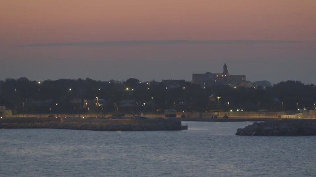 Wide, coastal Monopoli cityscape at dusk