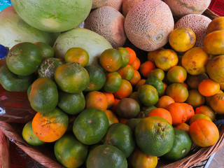 Limes, watermellons and canteloupe at a local market