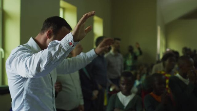 Man praying with raised hands