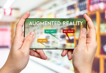 Hand hold mobile phone and using augmented reality ( AR ) app for see promotion sale in supermarket...