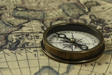 Retro compass with old map