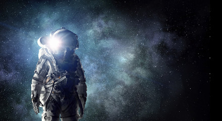 Fototapeta na wymiar Astronaut explorer in space. Mixed media