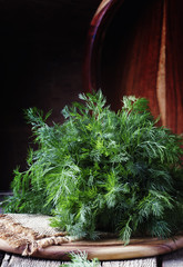 Fresh dill on the old wooden table, rustic style, selective focus