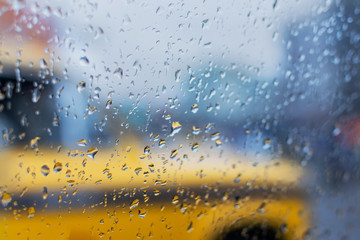 Monsoon abstract image, yellow taxi