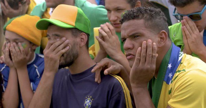 Brazilian fans looking disappointed during football match slow motion