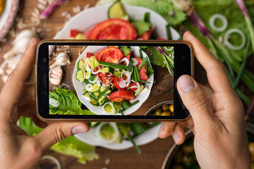 Phone photography of food. Woman hands take photo of lunch with smartphone for social media. Fresh...