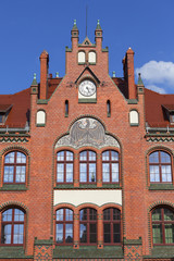 Fototapeta na wymiar Renovated facade of junior high school with Black Prussian eagle, Wroclaw, Poland