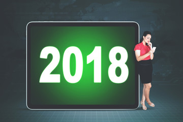 Young entrepreneur with number 2018 on the tablet
