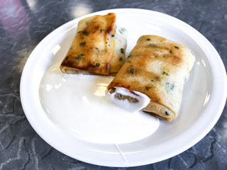 Stuffed pancakes with sour cream