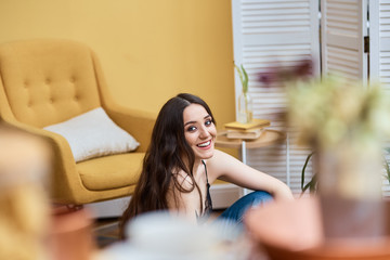 close-up portrait of young smiling woman in living room