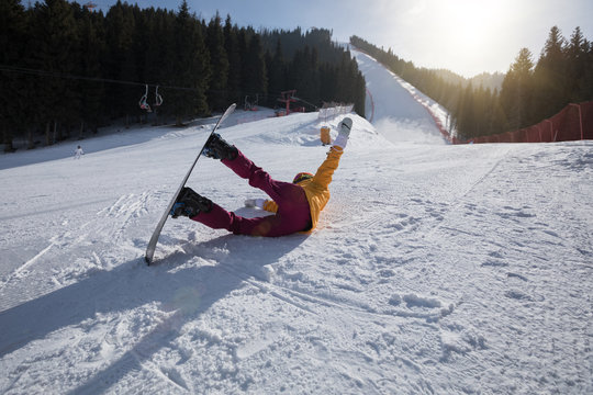 woman snowboarding in winter mountains