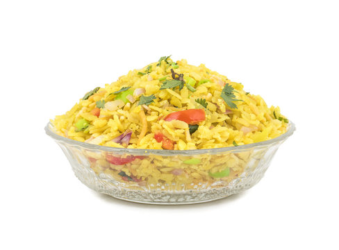 Indian Breakfast Dish Poha Also Know as Pohe or Aalu poha made up of Beaten Rice or Flattened Rice. The rice flakes are lightly fried in oil with mustard, chilly, onion, curry leaves and turmeric
