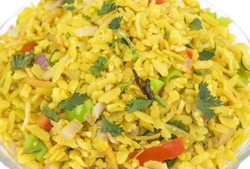 Indian Breakfast Dish Poha Also Know as Pohe or Aalu poha made up of Beaten Rice or Flattened Rice. The rice flakes are lightly fried in oil with mustard, chilly, onion, curry leaves and turmeric