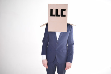The businessman is holding a box with the inscription:LLC
