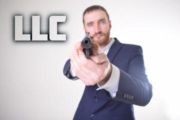 The businessman holds a gun in his hand and shows the inscription:LLC